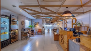 A modern interior with a reception desk, wooden accents, and a large window. - B&B Hotels Rio de Janeiro Norte (Rio de Janeiro)