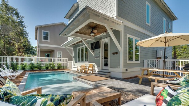 A two-story house with a swimming pool, outdoor seating, and a covered patio area. - Sea Glass Cottage ~ Private Pool ~ Private Beach Access ~ Golf Cart Included! (Miramar Beach)