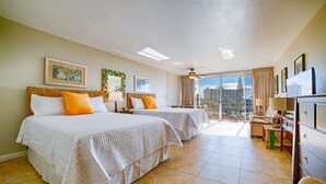 A hotel room with two beds, a desk, and a view of the city. - Stunning ocean views & direct beach access (Lahaina)