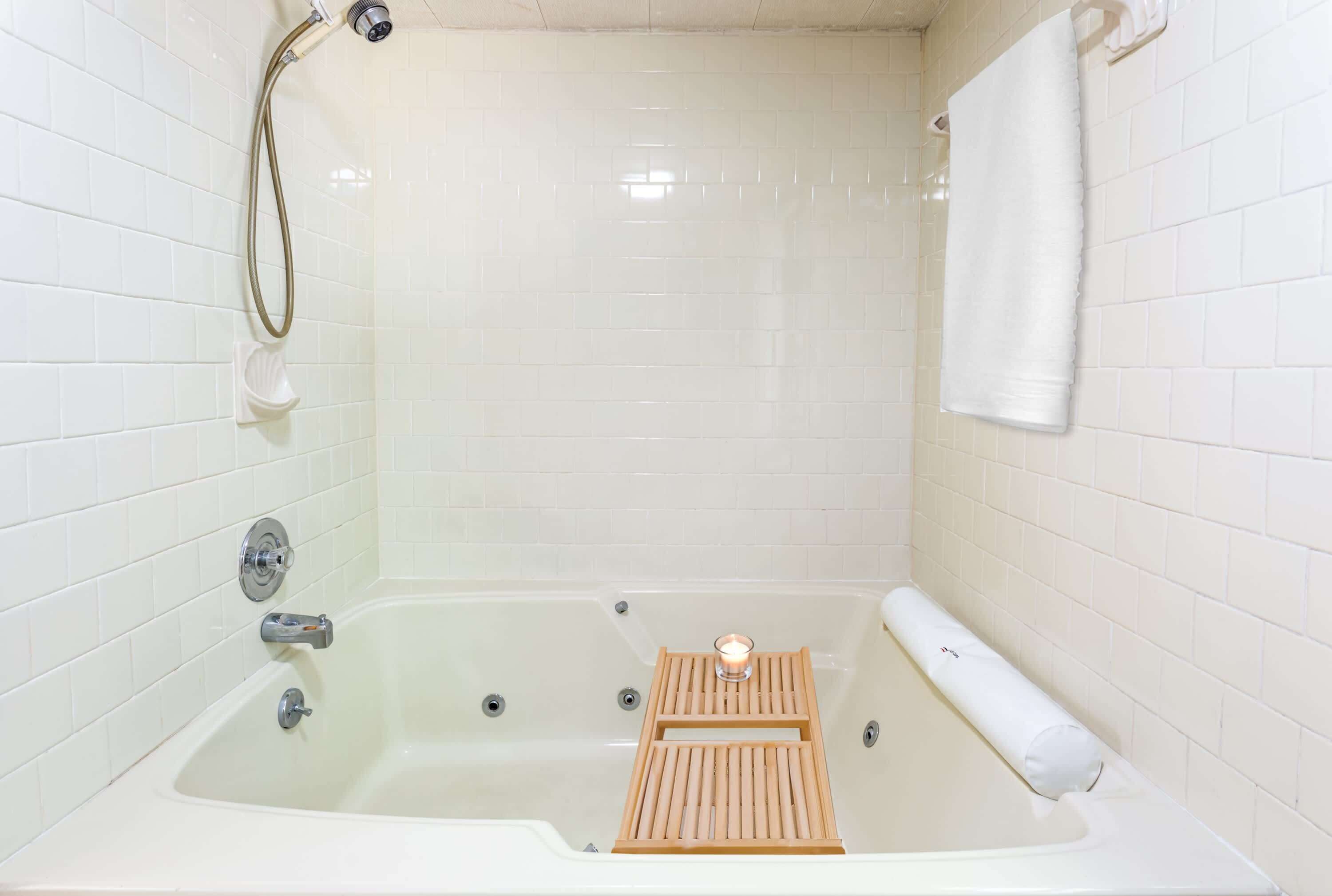 Bathtub, hair dryer, towels, shampoo