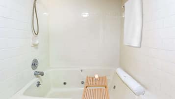 Bathtub, hair dryer, towels, shampoo