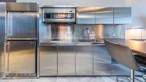 A modern kitchen with stainless steel appliances, a built-in microwave, and a sink.