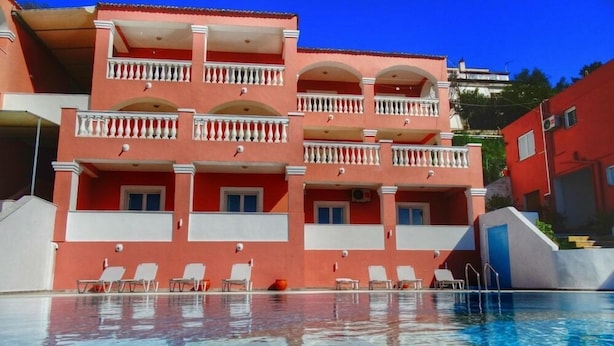 A multi-story hotel with balconies and a swimming pool. - Paradiso Apartments (Corfu)
