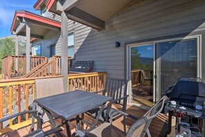 Enjoy al fresco dining on the deck with a grill and comfortable seating.