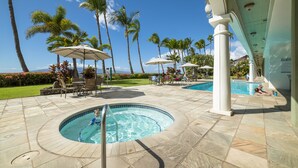 A pool area with a hot tub, lounge chairs, and umbrellas. - Lahaina Shores Beach Resort Studio (Lahaina)