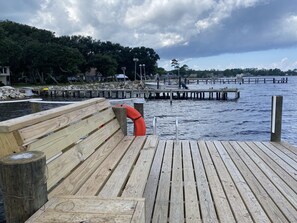 Guests can enjoy a peaceful moment on the pier, taking in the serene views of the water from the wooden bench.