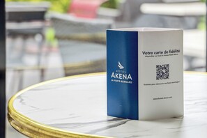 A loyalty card for Hotel Akena on a marble table. - Hotel AKENA La Ferté Bernard (Cherré-Au)
