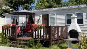 A mobile home with a deck, outdoor seating, and a built-in grill. - Mobile Home in Kolczewo near Baltic Beaches (Kolczewo)