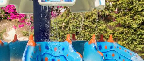 A water feature with a blue and white design, including a wave-like structure and a yellow circular element at the bottom.