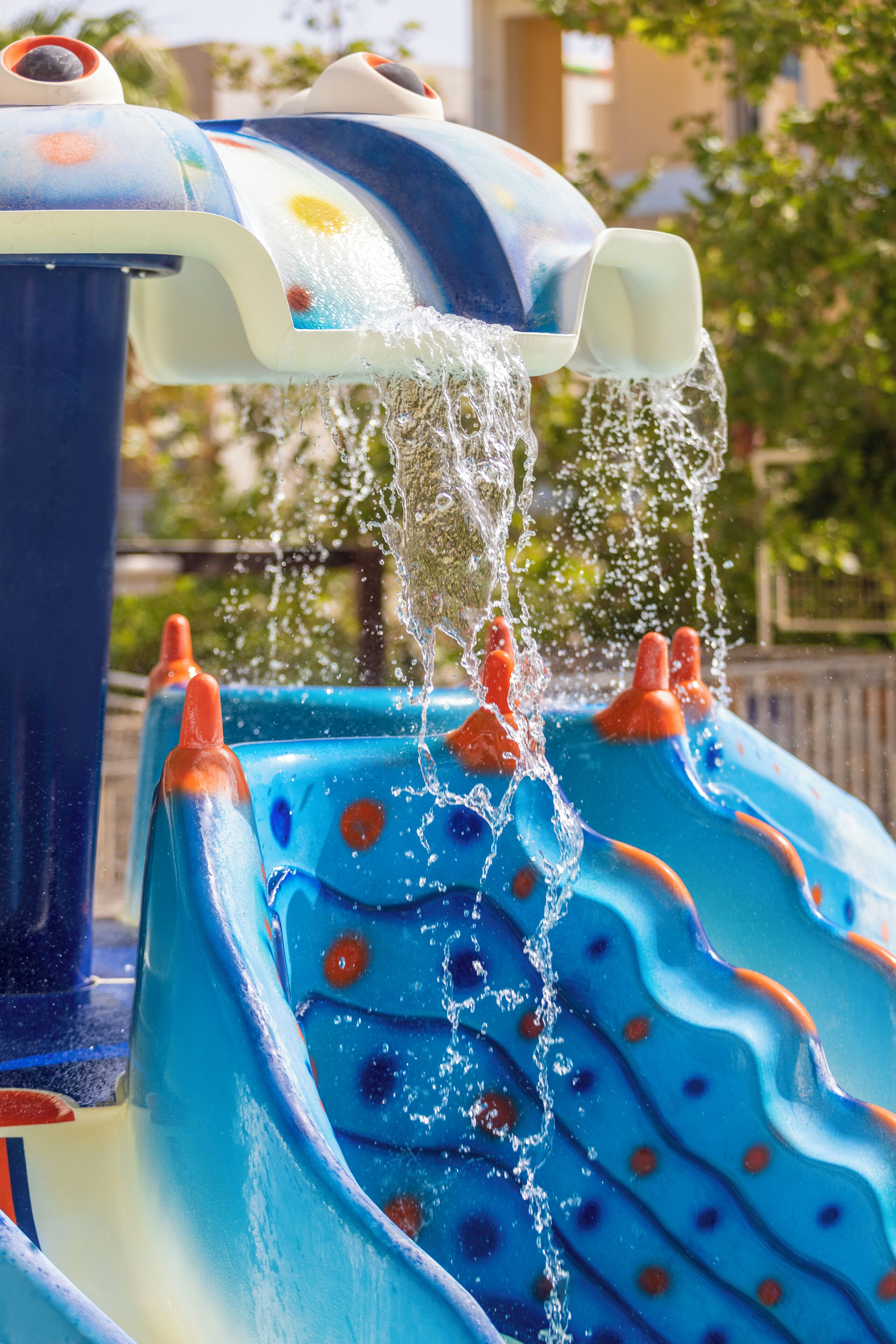 A water feature with a blue slide and orange accents.