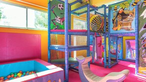 A colorful indoor play area with a ball pit, a slide, and a climbing structure. - Ibiscos Garden Hotel (Rethymno)