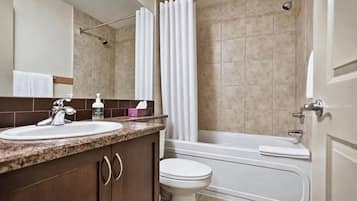 A bathroom with a sink, toilet, and bathtub.