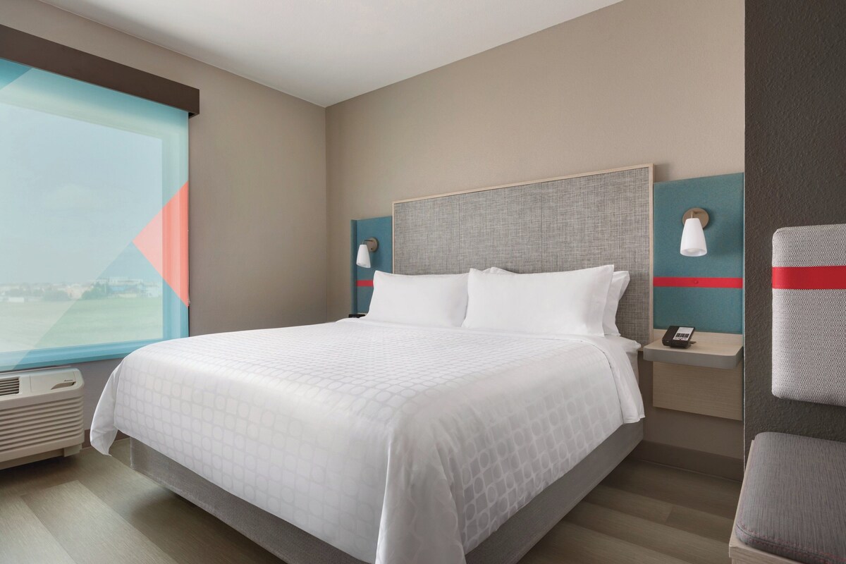 Premium bedding, desk, laptop workspace, blackout drapes