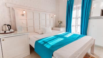 A neatly arranged bedroom with a bed, bedside table, and a small cabinet.