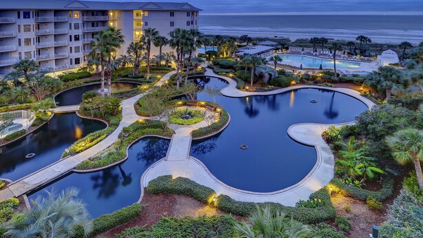 A resort with multiple swimming pools, a beachfront view, and a large building with balconies. - 2303 Seacrest - 2 Oceanfront Pools, Beach Bar, & Steps to the Beach! (Hilton Head Island)