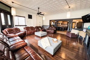 Grand House | Living area | 70-inch flat-screen TV with digital channels, TV - The Pub with Private Yard & Parking, Near the Falls & Casino by Niagara Hospitality (Niagara Falls)