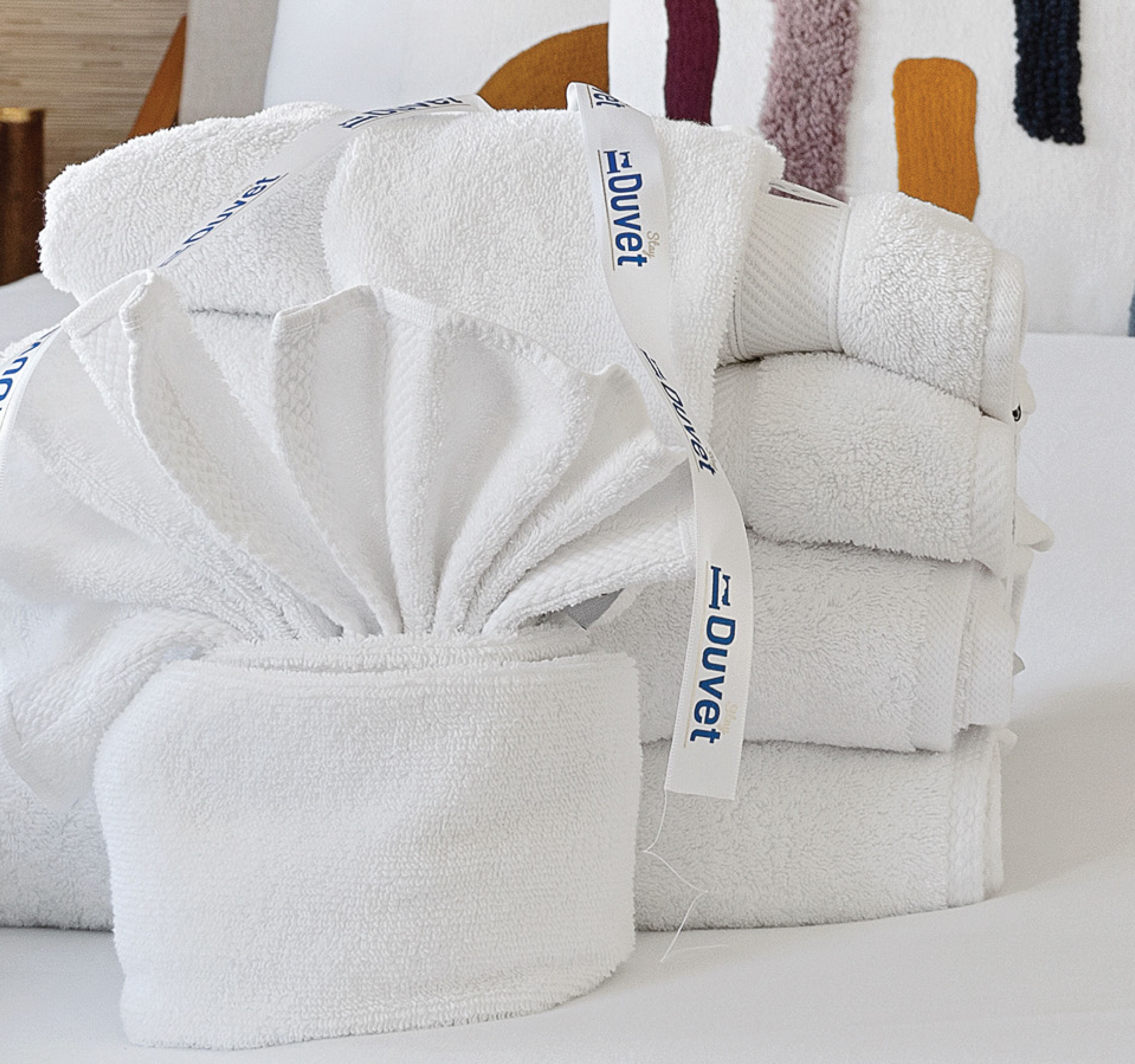 A stack of white towels with a label that reads "Duvet."