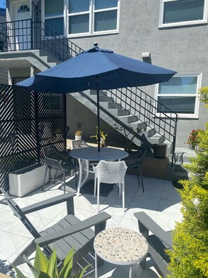 Enjoy dining or socializing in this well-maintained patio area with a round table and comfortable seating.