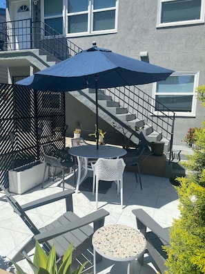 Enjoy dining or socializing in this well-maintained patio area with a round table and comfortable seating.