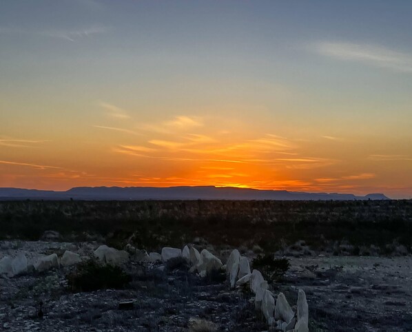 A desert landscape with a sunset.