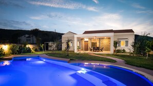 A modern house with a swimming pool, a patio with outdoor furniture, and a well-maintained lawn. - Three Stars Luxury Villas (Corfu)
