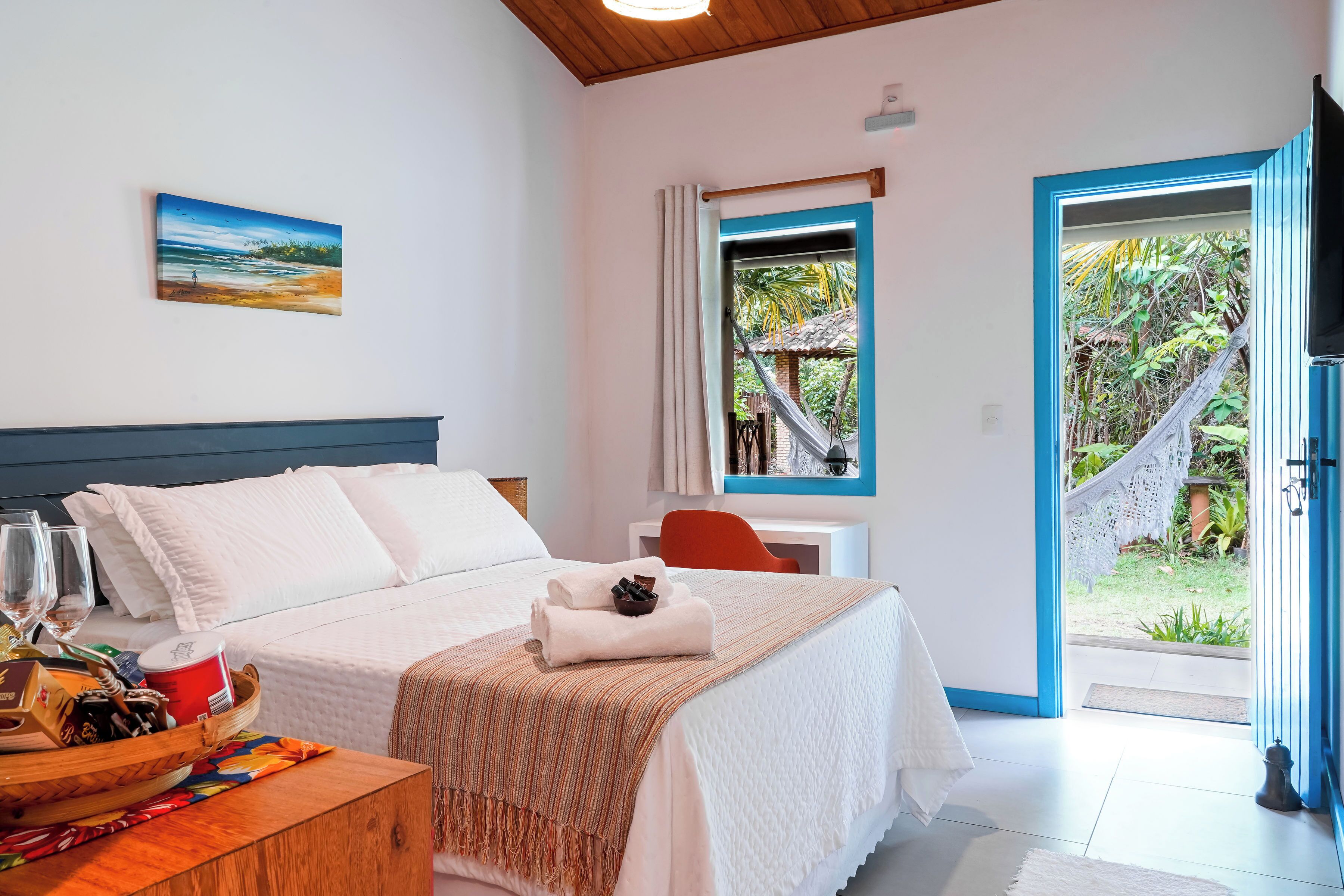 Un dormitorio con cama, mesita de noche y vistas al exterior.