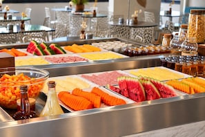 A buffet with various food items including fruits, cheeses, and meats. - D8 Hotel Express (Fortaleza)