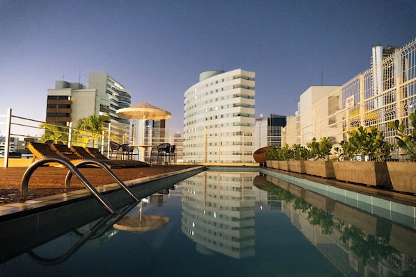 Outdoor pool, open 8:00 AM to 8:00 PM, pool umbrellas, pool loungers