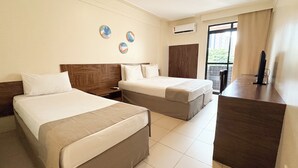 A hotel room with two beds, a desk, a wardrobe, and a window with curtains. - D8 Hotel Express (Fortaleza)