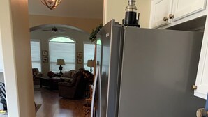 A kitchen with a stainless steel refrigerator, blue cabinets, and a marble countertop. - VACATION PARADISE!!! (Tucson)