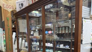 A bakery display case with various baked goods and a sign for Smith Family Popcorn at 1/2 price.