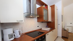 A compact kitchen with a coffee maker, an induction cooktop, and a microwave. - TANJA Studio with Balcony (Rovinj)