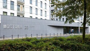 A modern building with a sign reading "MOSTOWA 23". - Elegant Apartment Near the Old Market Square | Parking (Poznań)