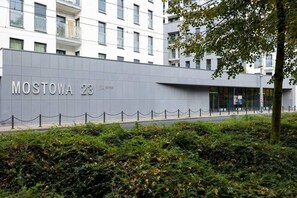 A modern building with a sign reading "MOSTOWA 23". - Elegant Apartment Near the Old Market Square | Parking (Poznań)