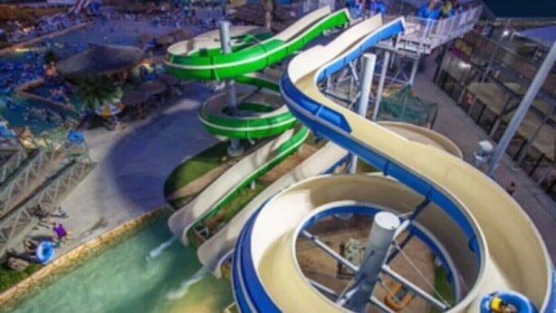 A water park with multiple water slides and a central circular pool. - "The Erin" ~ a nautical condo with beach & pond view (Corpus Christi)