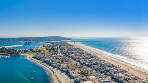 An aerial view of a coastal town with a beach, marina, and residential area. - Seas the Day on the Bay (San Diego)