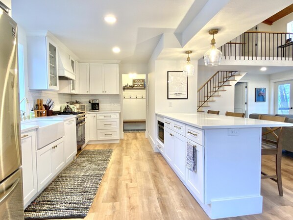 Enjoy cooking and coffee-making in this kitchen with a central island, oven, and coffee station.