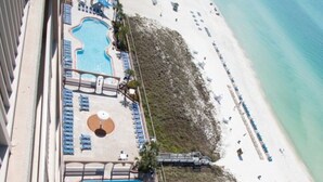 A resort with a pool area, lounge chairs, and a beach. - Great Weekly Rate With Beachfront Views (Panama City Beach)