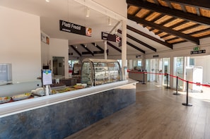 A buffet area with cold dishes and a clear exit sign.