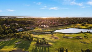 A golf course with bunkers, water hazards, and a clubhouse. - Albarella V3 1, Isola di Albarella, Italy (Isola di Albarella)