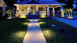 A two-story house with a front porch, a covered entryway, and a well-maintained lawn. - Historic Home Steps from Lake Hollingsworth, (Lakeland)