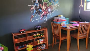Imaginative space for kids, featuring a vibrant mural and a selection of toys.