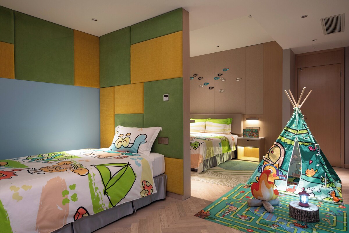 A children's room with a bed, a play area, and a tent.
