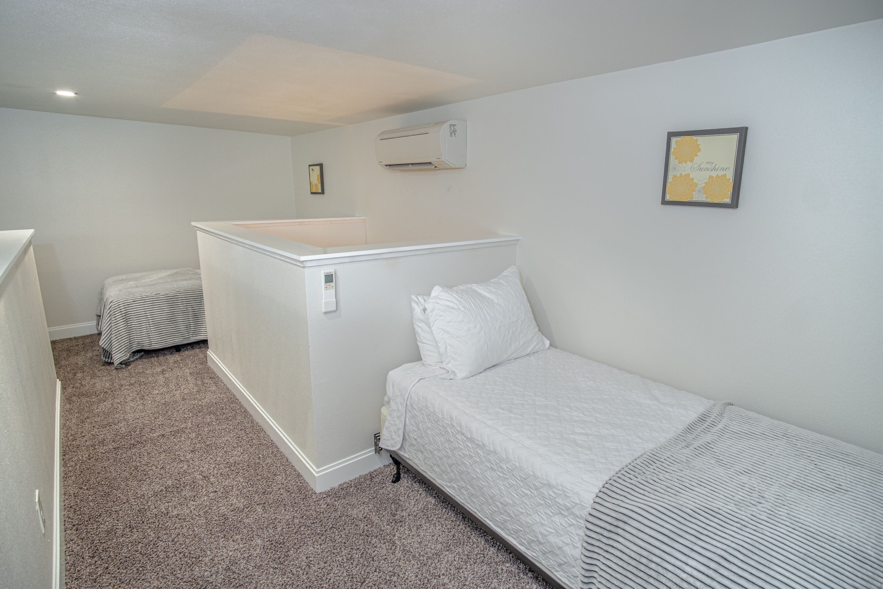 A room with a bed, a small desk, and a radiator.
