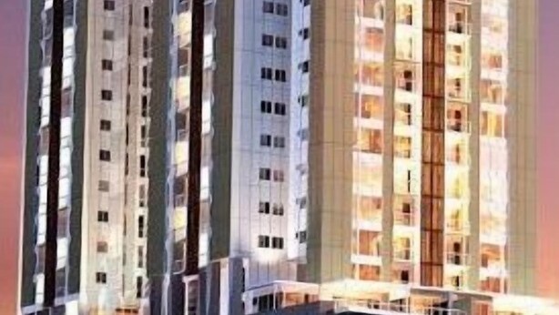 A high-rise residential building with multiple balconies and a modern architectural design. - My Resort BKK (Bangkok)