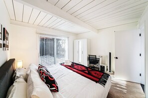 Relax in a spacious room with a large bed, desk, and wardrobe.