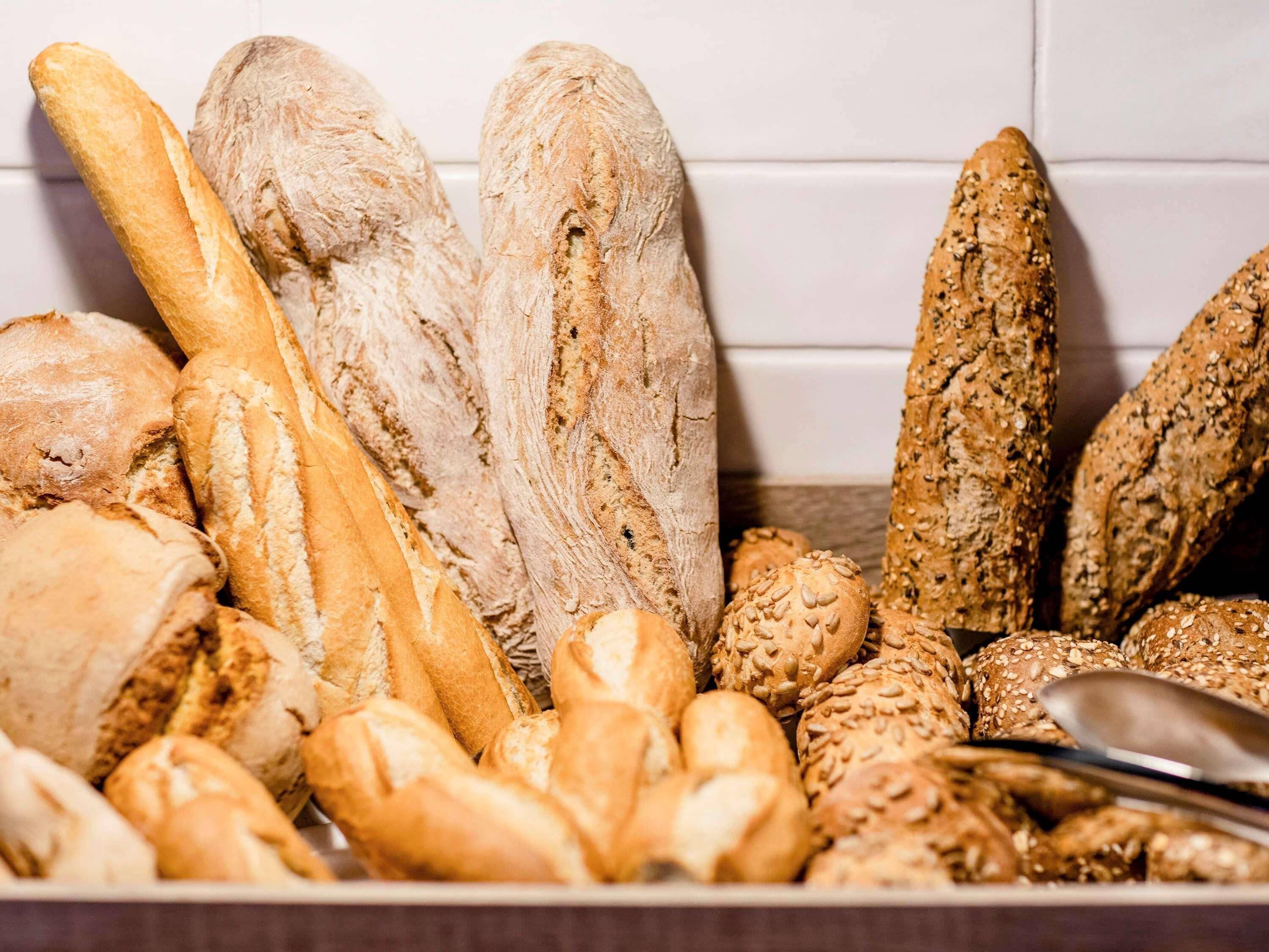 A variety of breads including baguettes and seeded rolls.