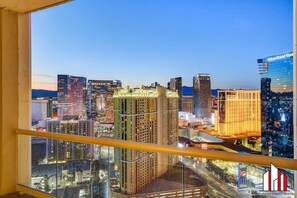 A cityscape view from a high-rise building at dusk. - MGM Signature Penthouse w/ F1 Strip View & Balcony (Las Vegas)