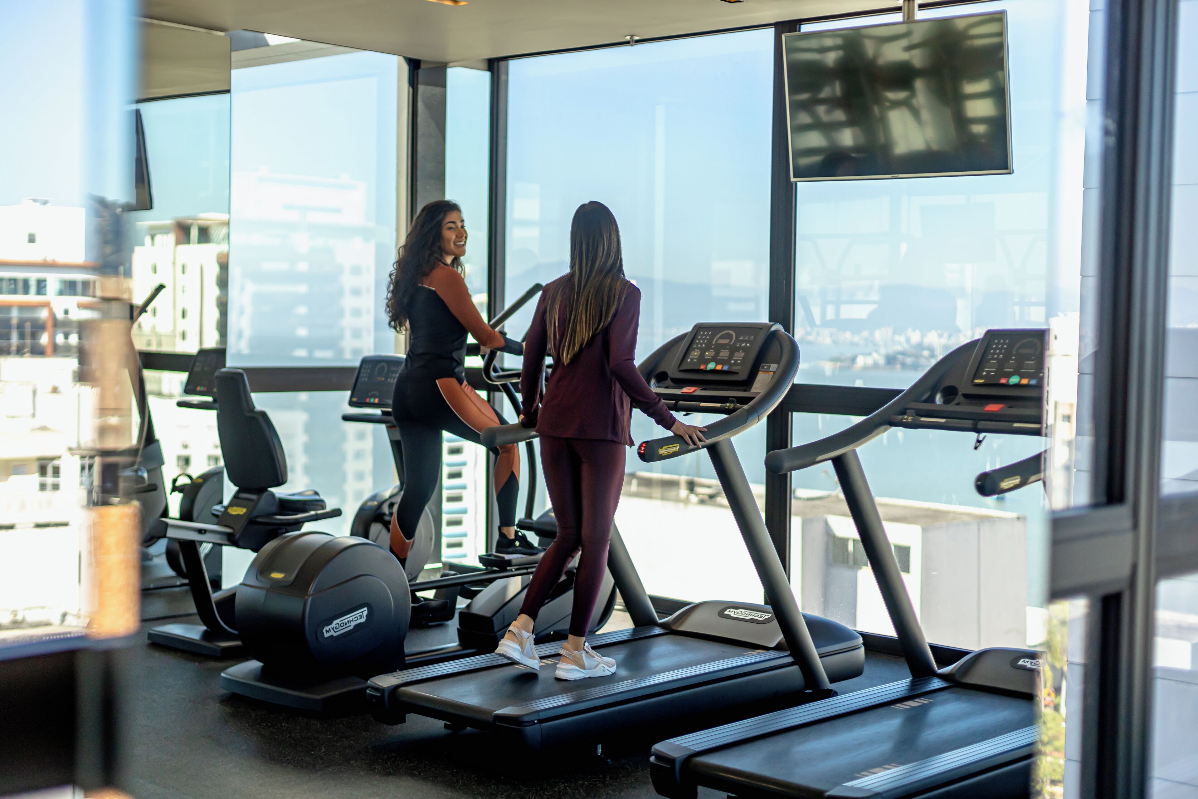 A gym with treadmills, stationary bikes, and elliptical machines.