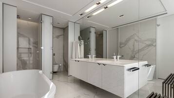 A modern bathroom with a freestanding bathtub, a large mirror, and a vanity with a geometric tile backsplash.